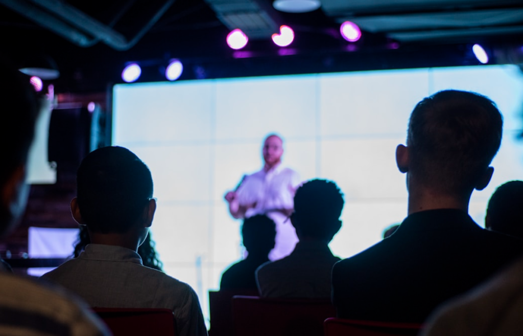 An instructor discussing 'account management software for your enterprise' with his attendees during his seminar